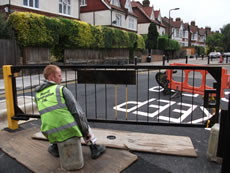 Yellow/black gate jct Goldsmith Road/Ave in Acton