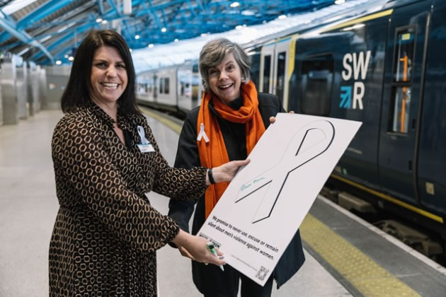 Claire Mann MD of SWR signing the White Ribbon Promise with Anthea Sully, Chief Executive of White Ribbon UK